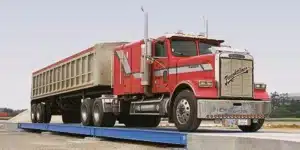 A truck being weighed on a permanent weighbridge truck scale.
