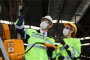 Industrial workers measuring the weight of a product in a warehouse.