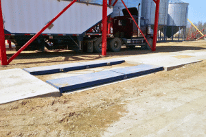 Massload Farm Truck Axle Scale in front of a silo